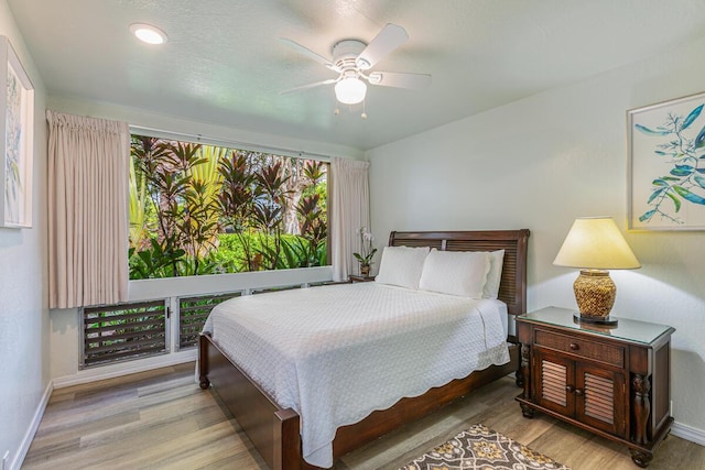 bedroom featuring hardwood / wood-style flooring and ceiling fan