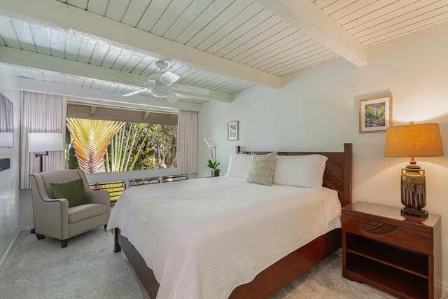 bedroom featuring beamed ceiling, light carpet, ceiling fan, and wooden ceiling