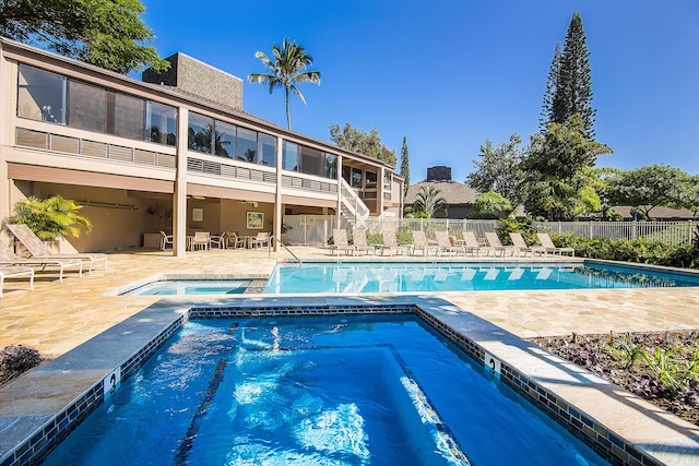 view of pool featuring a patio area and a community hot tub