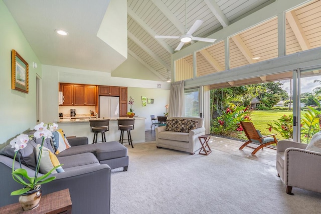 carpeted living room featuring ceiling fan, beamed ceiling, and high vaulted ceiling