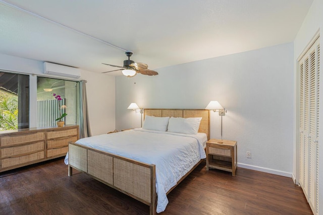 bedroom with ceiling fan, dark hardwood / wood-style flooring, a closet, and an AC wall unit