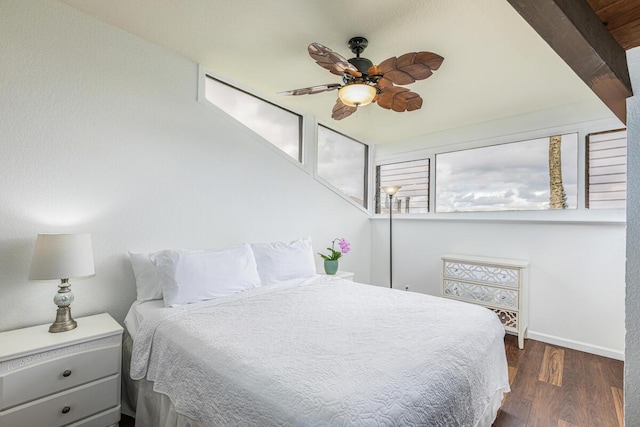 bedroom with dark hardwood / wood-style floors and ceiling fan