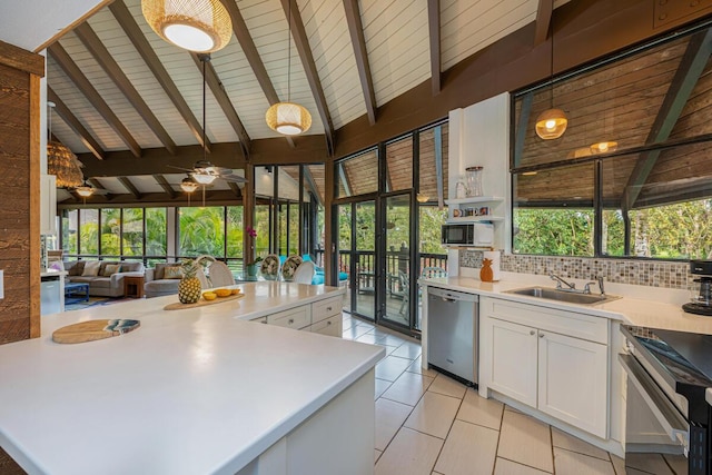 kitchen with light tile patterned flooring, pendant lighting, tasteful backsplash, white cabinetry, and stainless steel appliances