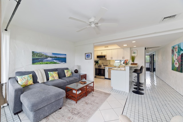 tiled living room with ceiling fan