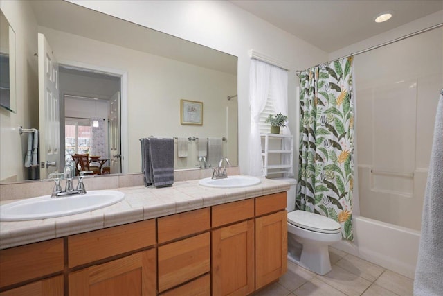 full bathroom with tile patterned floors, shower / tub combo with curtain, vanity, and toilet