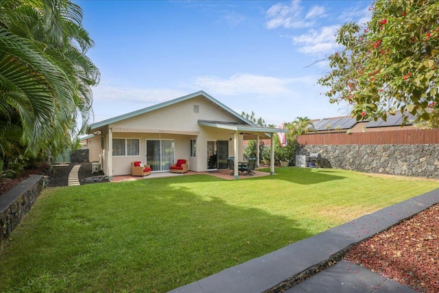 rear view of house with a yard and a patio area