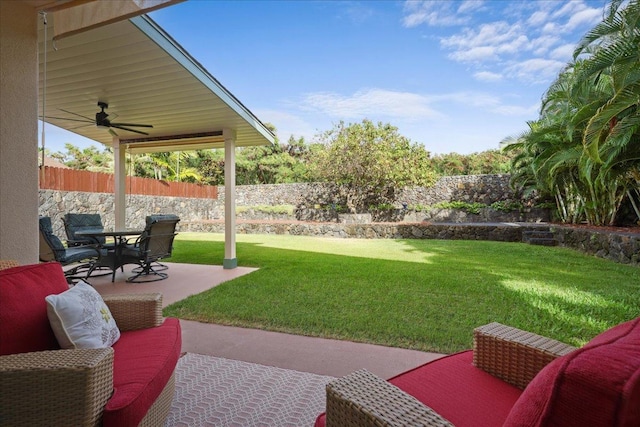 view of yard featuring ceiling fan and a patio