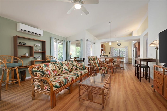 living room with high vaulted ceiling, light hardwood / wood-style flooring, a wall mounted AC, and ceiling fan