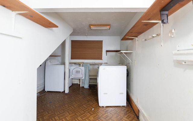 laundry room with washing machine and dryer and dark parquet floors