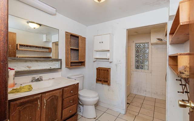 bathroom with vanity, a shower, tile patterned flooring, and toilet