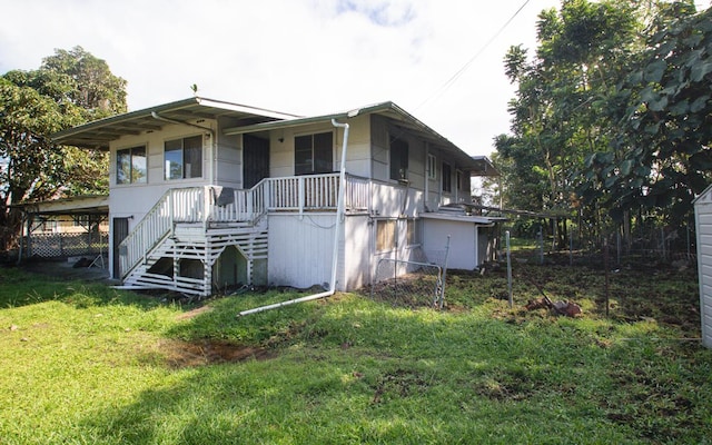 rear view of house with a yard