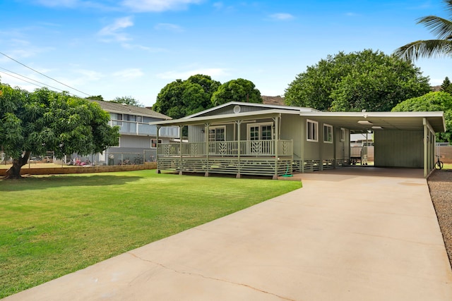 exterior space featuring a lawn, covered porch, and a carport