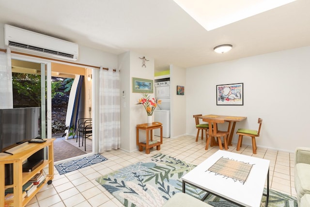 living room featuring light tile patterned floors, stacked washing maching and dryer, and a wall mounted AC