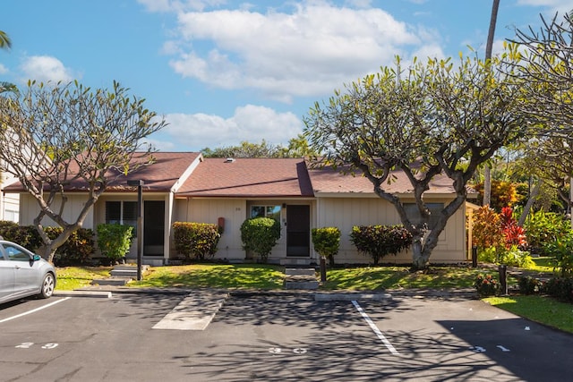 ranch-style home with a front lawn