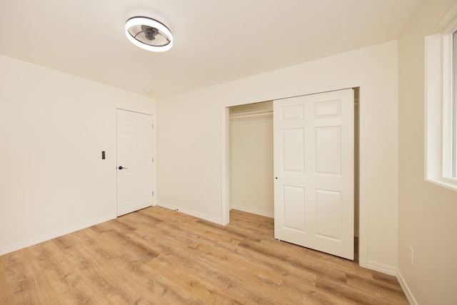 unfurnished bedroom with light hardwood / wood-style floors and a closet