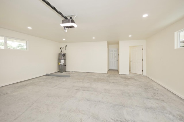 garage featuring electric water heater and a garage door opener