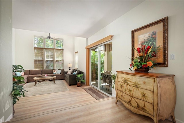 living area with plenty of natural light, ceiling fan, and light wood-type flooring