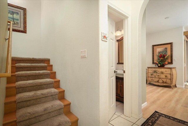 staircase with wood-type flooring