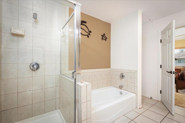 bathroom with tile patterned floors and independent shower and bath