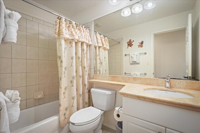 full bathroom with vanity, toilet, and shower / tub combo with curtain