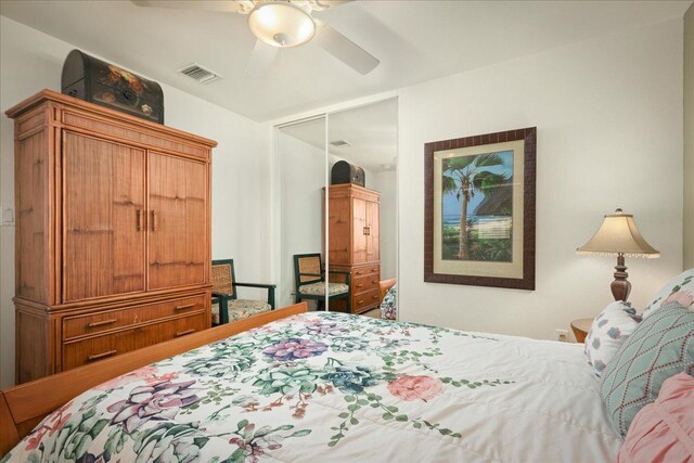 bedroom with ceiling fan and a closet