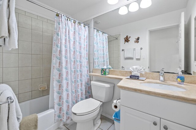 full bathroom featuring tile patterned flooring, shower / tub combo, vanity, and toilet