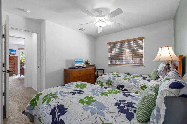 bedroom with light carpet and ceiling fan