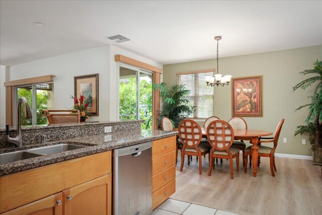 kitchen featuring dishwasher, light hardwood / wood-style floors, plenty of natural light, and sink