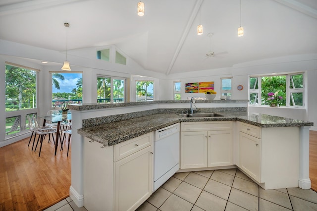 kitchen featuring lofted ceiling with beams, dishwasher, white cabinets, light hardwood / wood-style floors, and hanging light fixtures