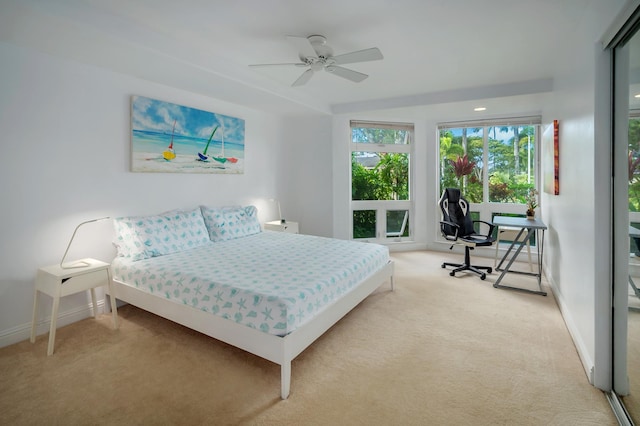 bedroom with ceiling fan and light colored carpet