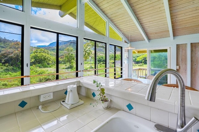 unfurnished sunroom featuring wood ceiling and lofted ceiling with beams