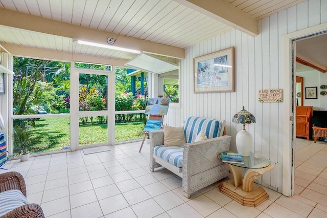 sunroom featuring beam ceiling