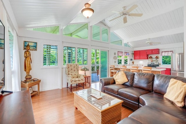 living room with vaulted ceiling with beams, light wood-type flooring, and ceiling fan