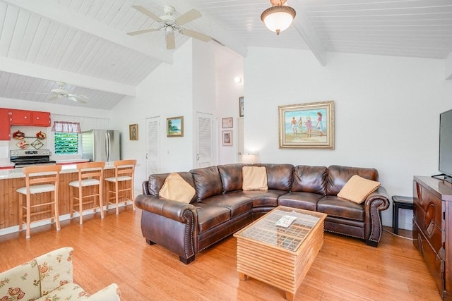 living room featuring ceiling fan, light hardwood / wood-style floors, beam ceiling, and high vaulted ceiling