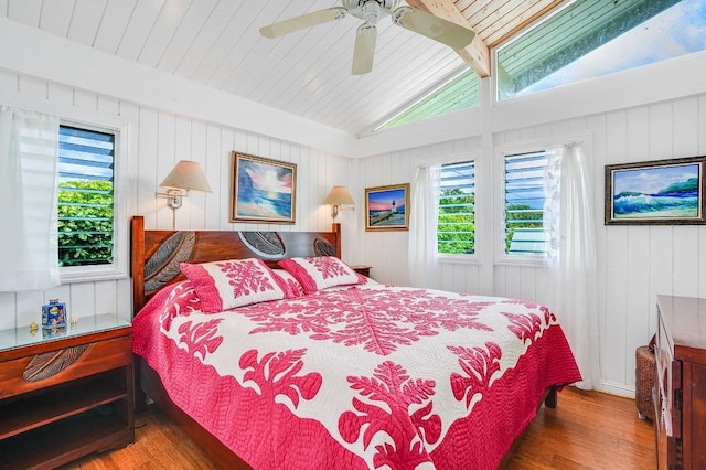 bedroom featuring ceiling fan, hardwood / wood-style floors, and lofted ceiling