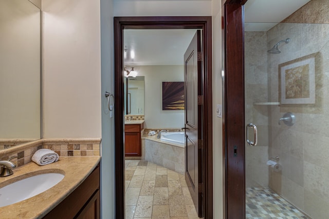 bathroom with vanity and separate shower and tub