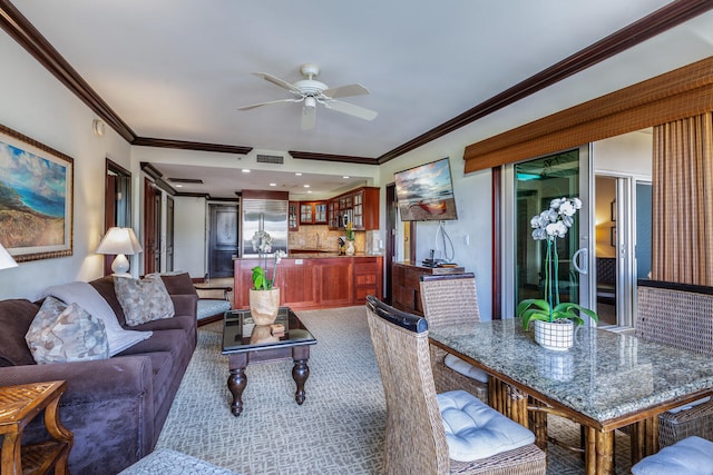 living room with ceiling fan and ornamental molding