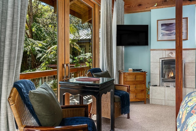 sunroom / solarium with a tile fireplace