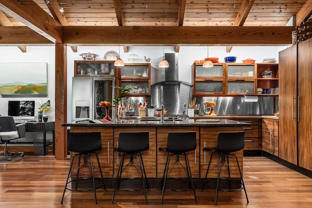 bar with light hardwood / wood-style floors, wooden ceiling, beam ceiling, and island range hood