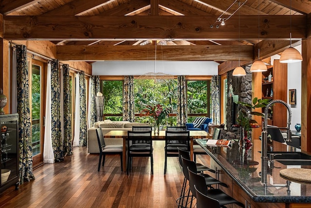 dining room featuring dark hardwood / wood-style flooring, wooden ceiling, and a healthy amount of sunlight