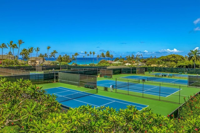 view of tennis court featuring a water view