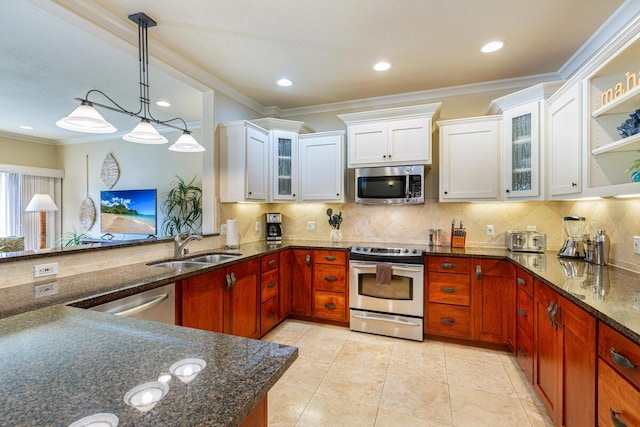 kitchen with white cabinetry, sink, stainless steel appliances, pendant lighting, and ornamental molding