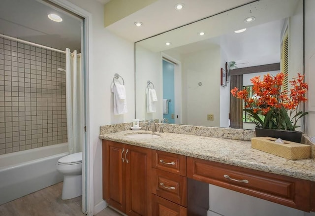 full bathroom with wood-type flooring, vanity, toilet, and shower / bath combination with curtain