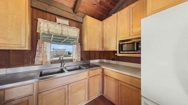 kitchen featuring light brown cabinetry, lofted ceiling, sink, white refrigerator, and wood ceiling