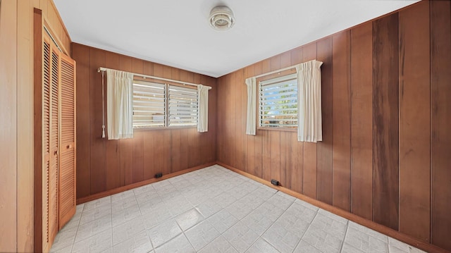 empty room featuring wood walls