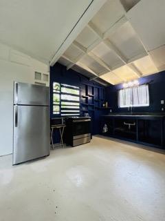 garage with stainless steel refrigerator