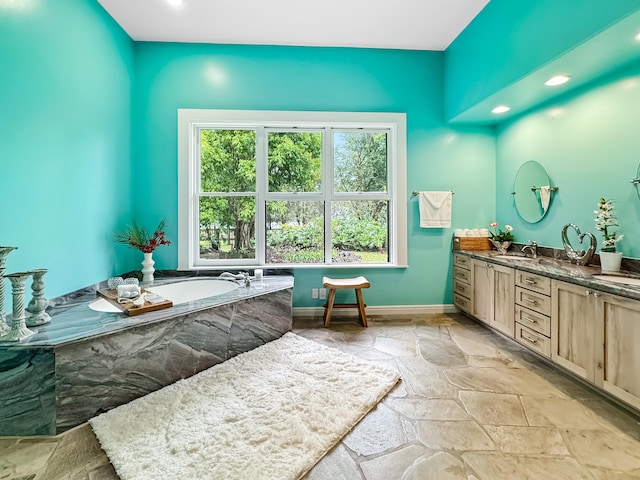 bathroom featuring a washtub and vanity