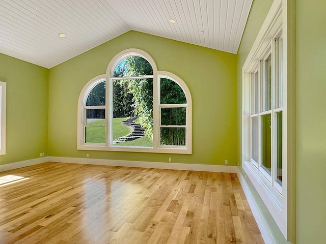 unfurnished room with light wood-type flooring, vaulted ceiling, and wooden ceiling