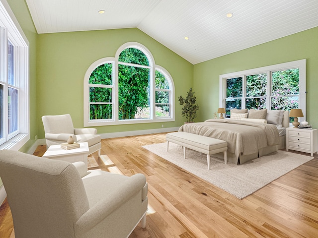 bedroom with light hardwood / wood-style floors, vaulted ceiling, and wood ceiling