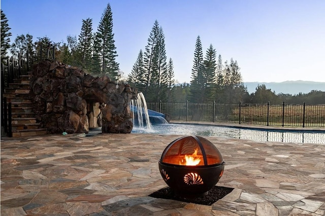 view of pool featuring an outdoor fire pit